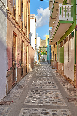 Buy stock photo Empty cobbled street in a rural European tourist town. A quiet narrow alley way with colorful apartment buildings or houses. Hidden side street with traditional architecture in Santa Cruz de La Palma