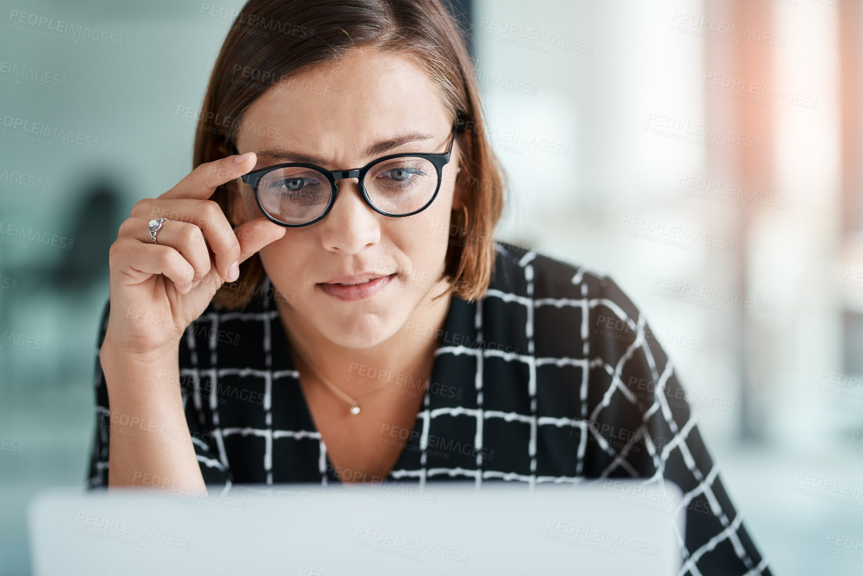 Buy stock photo Woman, internet and confused in office for reading miscommunication, unclear instructions and new software. Girl, glasses and online with laptop or uncertain for information overload and research.