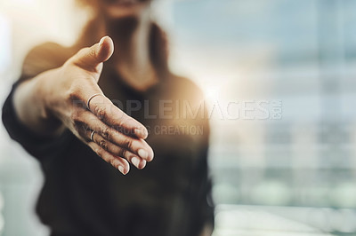 Buy stock photo Cropped shot of an unrecognizable businesswoman gesturing a handshake in a modern office