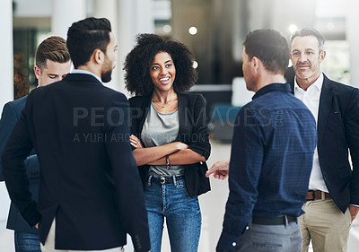 Buy stock photo Shot of a group of businesspeople having a discussion together at work during the day