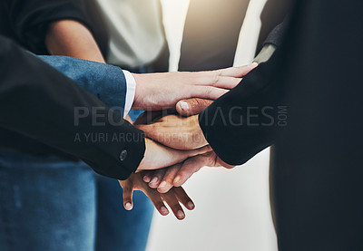 Buy stock photo Shot of a group of unrecognizable businesspeople forming a huddle with their hands at work