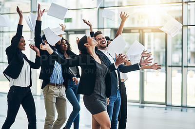 Buy stock photo Shot of a group of cheerful businesspeople lifting their hands in joy while being funny inside of the office at work