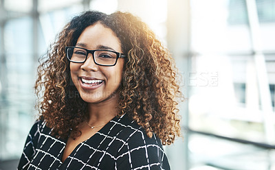 Buy stock photo Cropped portrait of an attractive young businesswoman smiling while standing in a modern office