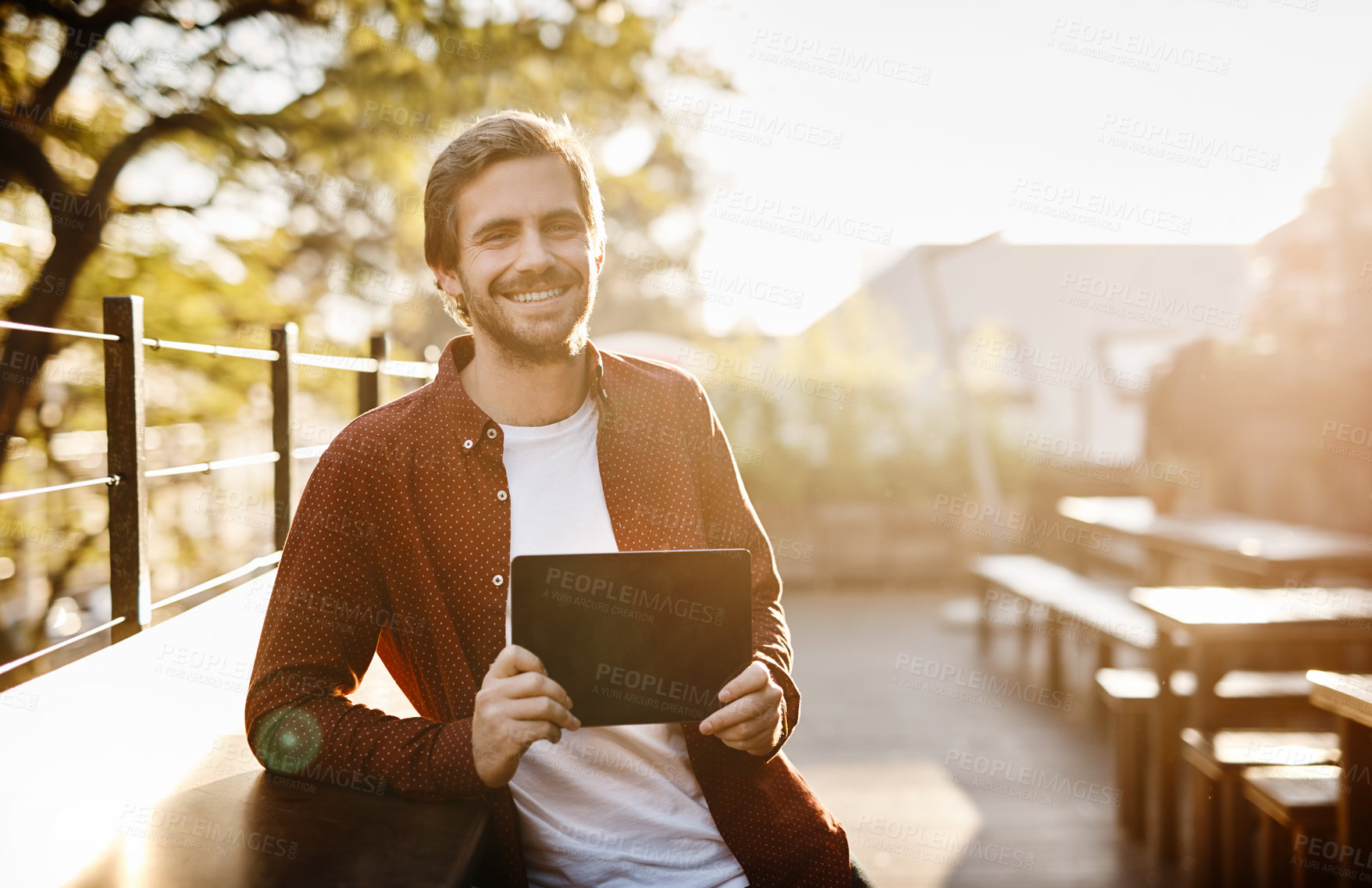 Buy stock photo Cropped portrait of a handsome young man showing you the screen of his digital tablet outside