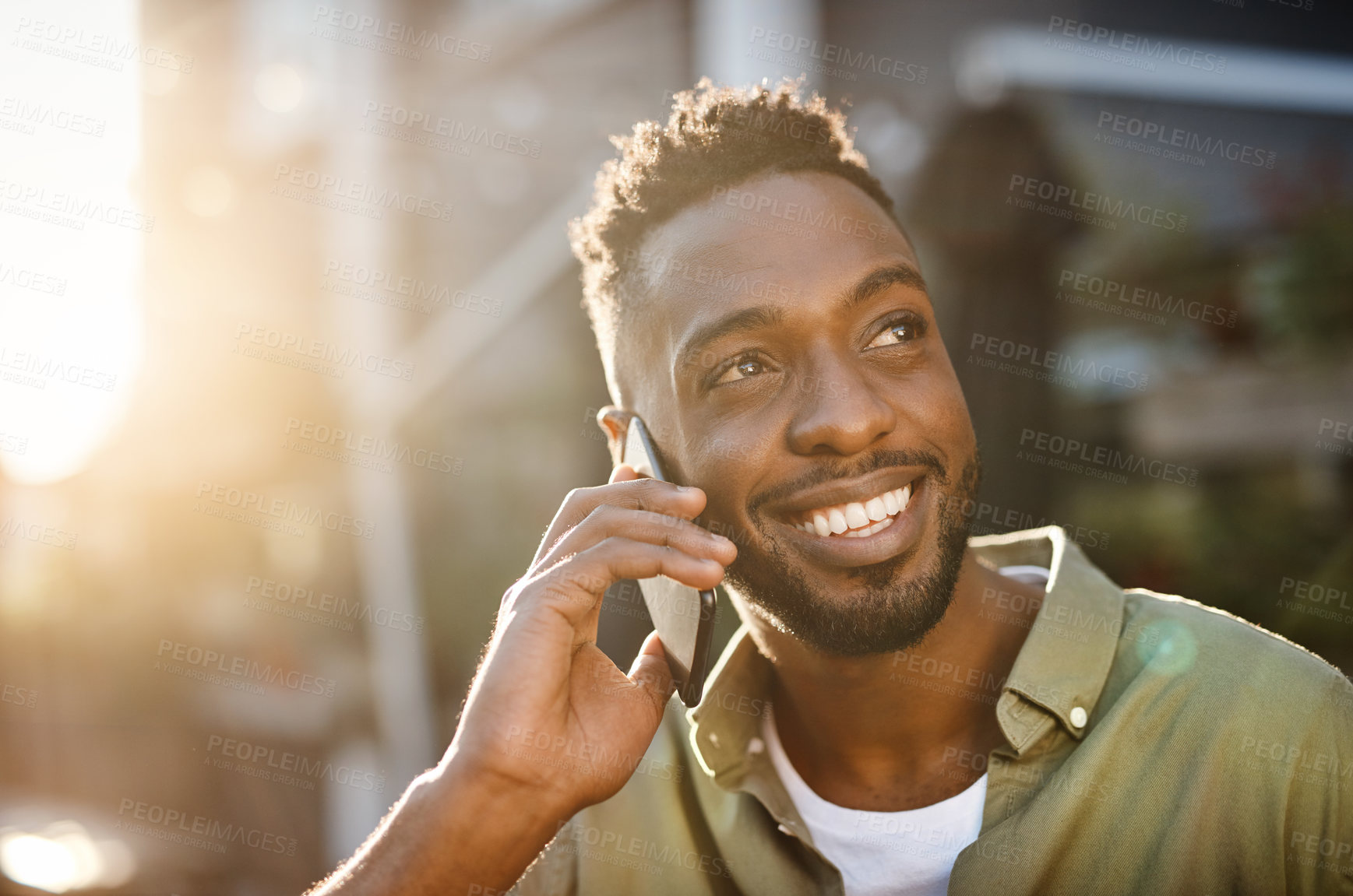 Buy stock photo Cropped shot of a handsome young man using his cellphone while standing outside