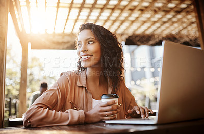 Buy stock photo Cropped shot of an attractive young woman using a laptop in a coffee shop