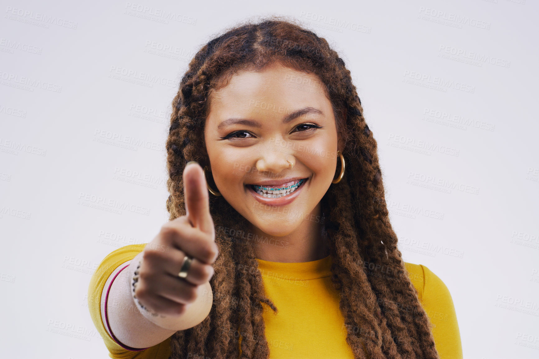 Buy stock photo Young woman, studio and portrait of thumbs up with agreement, vote or hand review with happiness by background. African model or sign for opinion, yes or thank you for motivation, winning and success