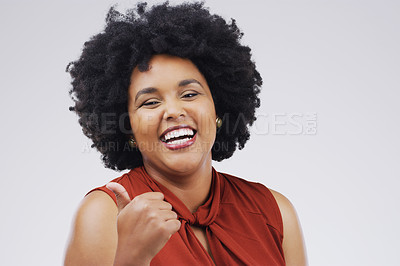 Buy stock photo Studio portrait of an attractive young woman giving a thumbs up against a grey background