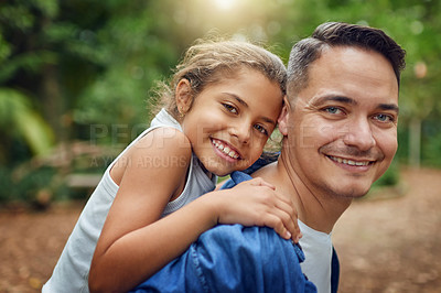 Buy stock photo Cropped portrait of a happy father piggybacking his daughter at the park