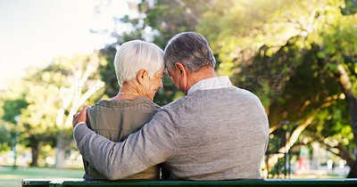 Buy stock photo Senior couple, hug and bench outdoor in a park with love, care and support in marriage. A elderly man and happy woman in nature with a smile for quality time, healthy retirement and freedom to relax