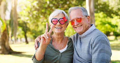 Buy stock photo Funny couple, peace sign and portrait outdoor at a park with love, care and hand emoji. A happy senior man and woman with comic sunglasses in nature for happiness, healthy marriage and retirement fun
