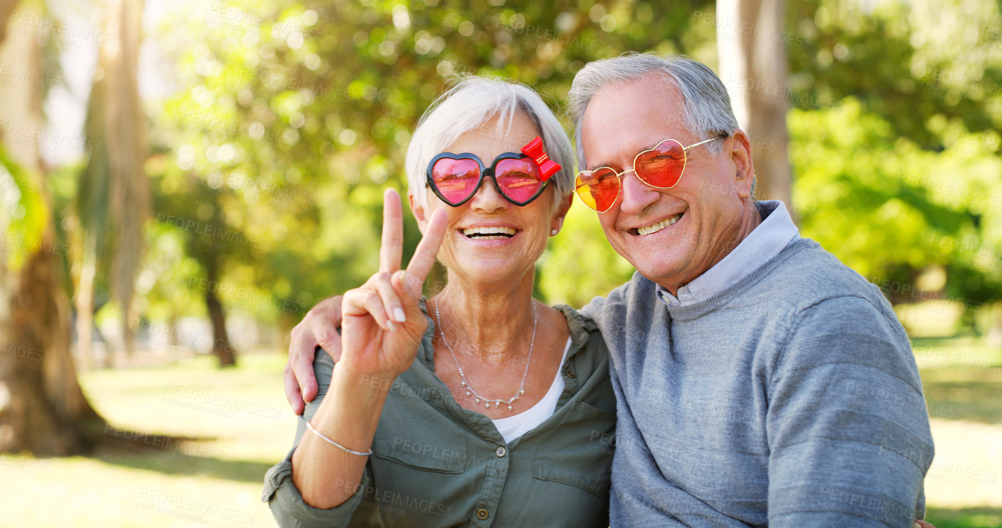 Buy stock photo Funny couple, peace sign and portrait outdoor at a park with love, care and hand emoji. A happy senior man and woman with comic sunglasses in nature for happiness, healthy marriage and retirement fun