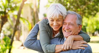 Buy stock photo Love, hugging and elderly couple in a garden together with care, happiness and romance. Smile, nature and senior man and woman in retirement embracing, laughing and sitting in an outdoor green park.