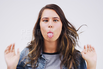 Buy stock photo Portrait, funny face and tongue with a woman in studio on a white background looking silly or goofy. Comedy, comic or crazy and a playful young female person joking indoor for humor with an emoji