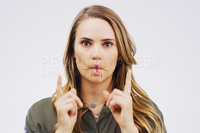 Buy stock photo Portrait, funny face and lips with a woman in studio on a gray background looking silly or goofy. Comedy, comic and crazy with a playful young female person puckering indoor for a joke, fun or humor