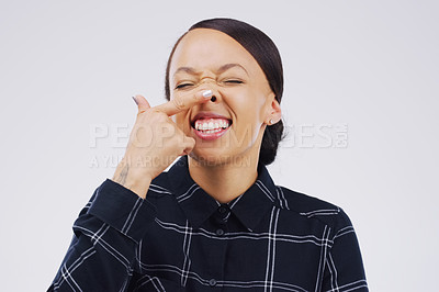 Buy stock photo Portrait, funny face and finger on nose with a woman laughing in studio on a white background for humor. Comic, comedy and showing nostrils with a playful young female person joking or having fun