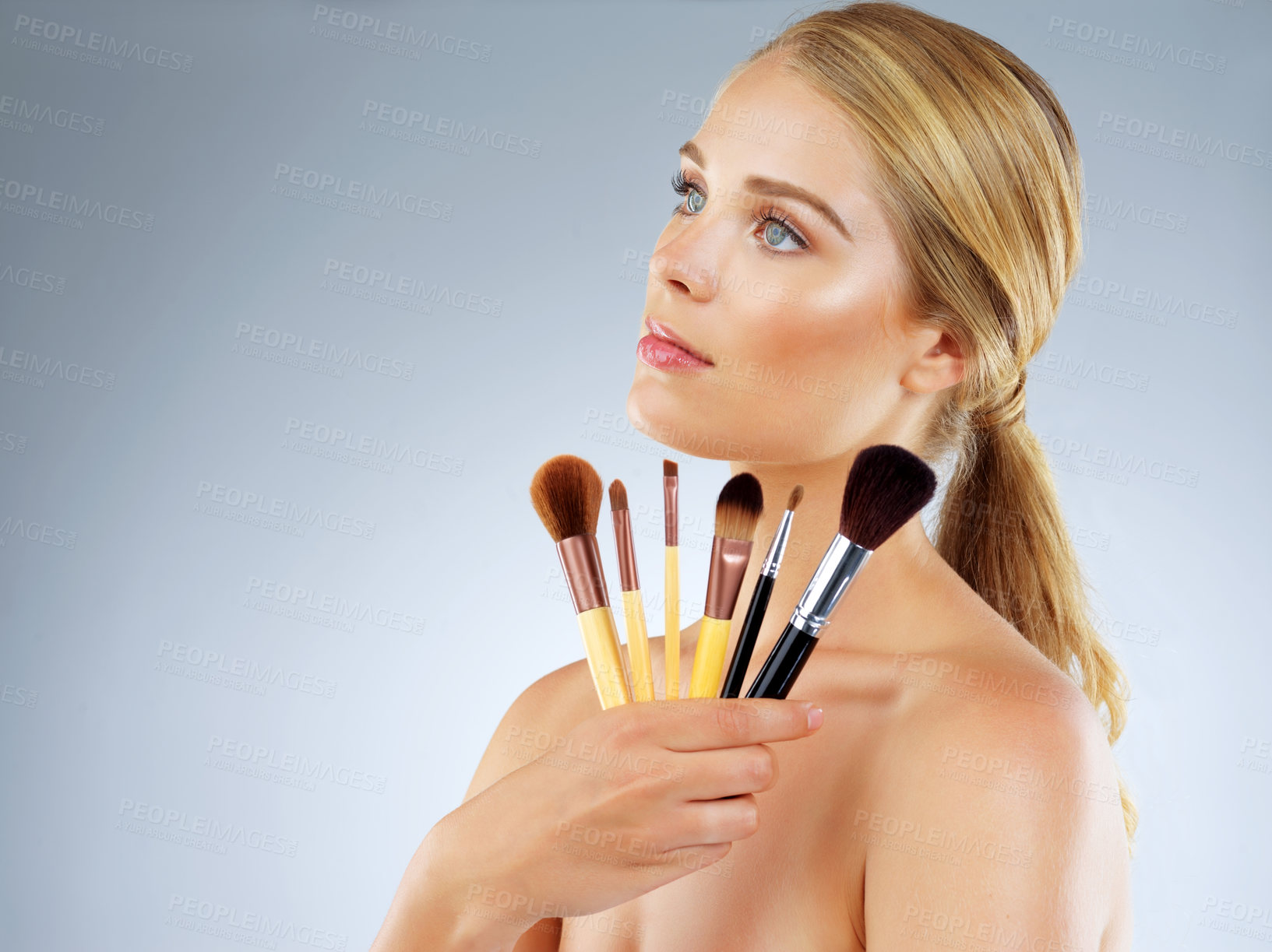 Buy stock photo Profile, woman and studio with brush for makeup or cosmetic application, beauty and foundation of aesthetic. Female person, tools and salon for glamour, transformation and glow on white background