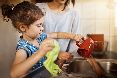 Buy stock photo Mom, child and learning to wash dishes in kitchen with cleaning, teaching and help in a family home. Cup, happy and love of parent and young girl together with bonding, support and sink with care