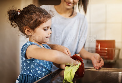 Buy stock photo Mother, child learn and washing dishes in kitchen with cleaning, teaching and help in a family home. Cup, happy and love of parent and young girl together with bonding, support and sink with care