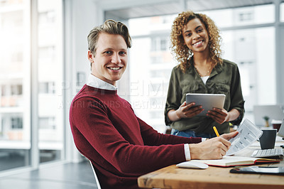 Buy stock photo Portrait of two young colleagues using a digital tablet together in a modern office