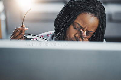 Buy stock photo Shot of a young woman suffering from stress while using a computer at her work desk