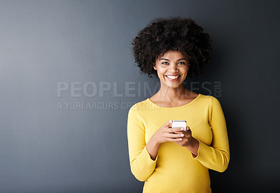Buy stock photo Social media, chat and portrait of black woman using phone or smile in studio, mockup and grey background. Cellphone, app or person typing contact or internet communication on website with happiness