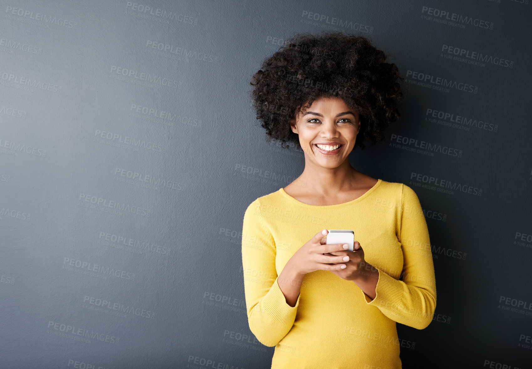 Buy stock photo Social media, chat and portrait of black woman using phone or smile in studio, mockup and grey background. Cellphone, app or person typing contact or internet communication on website with happiness