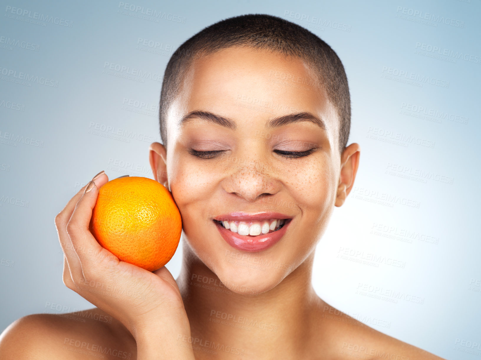 Buy stock photo Skincare, beauty and woman with orange in studio for natural, organic and facial treatment. Wellness, health and model with citrus fruit with vitamin c for face dermatology routine by gray background