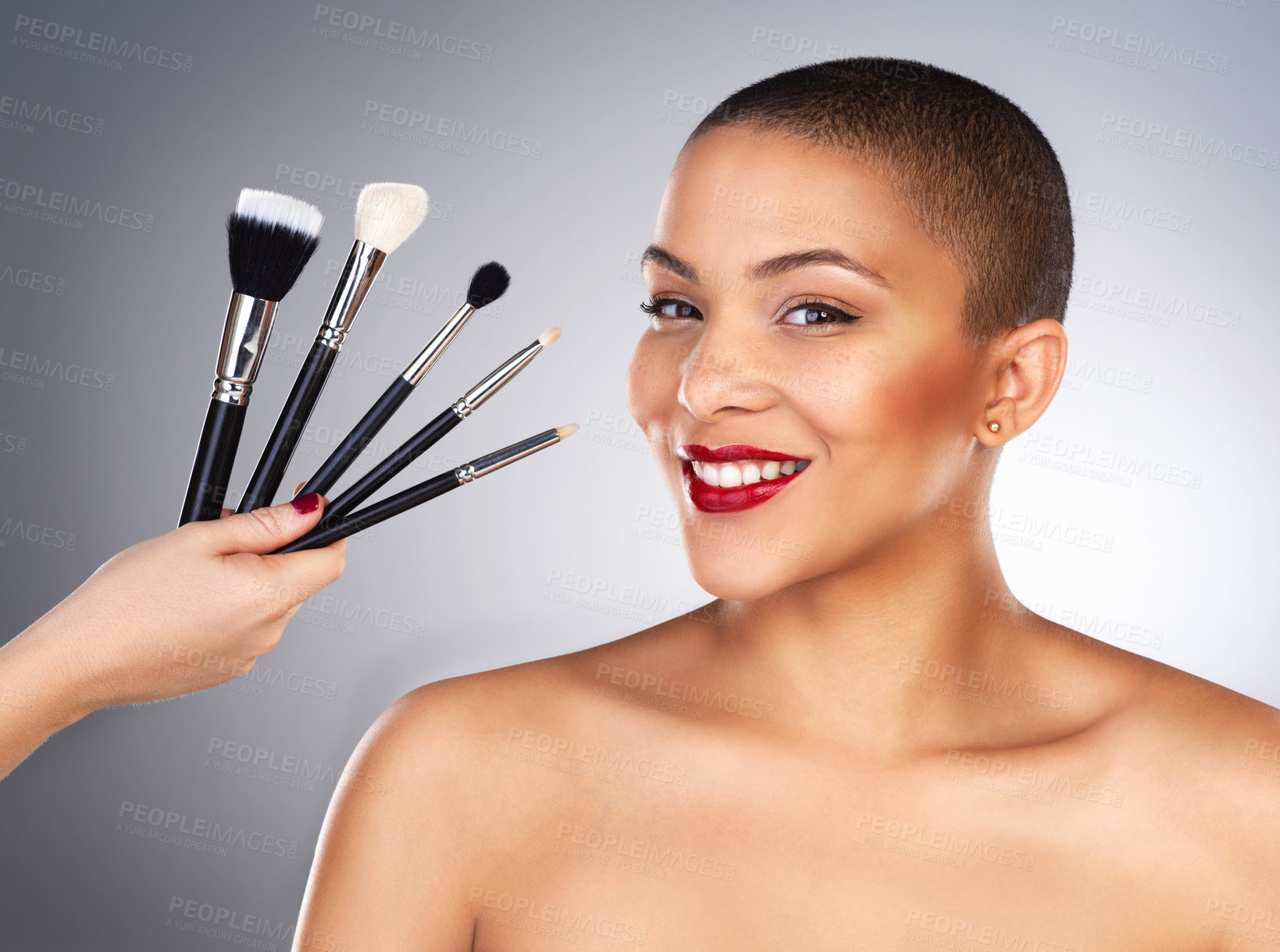 Buy stock photo Hand with brush, cosmetics and girl in portrait by studio background for wellness, beauty and makeup with smile. Cosmetology, female model and products for application, aesthetics or facial treatment
