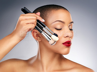 Buy stock photo Beauty, makeup brushes and face of woman with red lips in studio for lipstick and skin routine. Cosmetics, confident and female person with facial cosmetology treatment isolated by gray background.