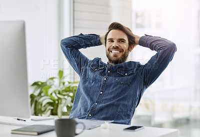 Buy stock photo Cropped shot of a handsome young businessman smiling while sitting with his hands behind his head in a modern office