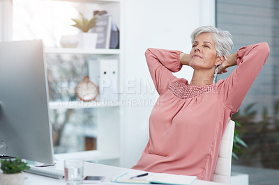 Buy stock photo Shot of a mature businesswoman laying back and relaxing in her chair at work