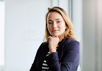 Buy stock photo Portrait of an attractive businesswoman posing with her hand on her chin at work