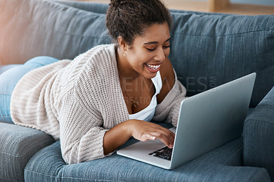 Buy stock photo Cropped shot of a happy young woman using her laptop to make a video call at home