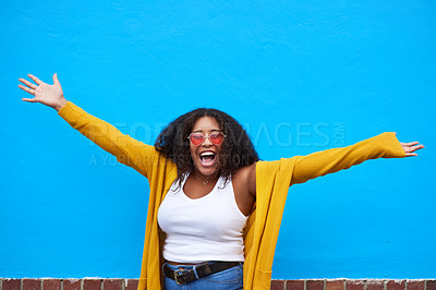 Buy stock photo Woman, portrait and excited at wall for fashion, trendy sunglasses and energy for deal. Girl, confident and happy at blue space for promotion, freedom and WOW in streetwear on Brazil sidewalk