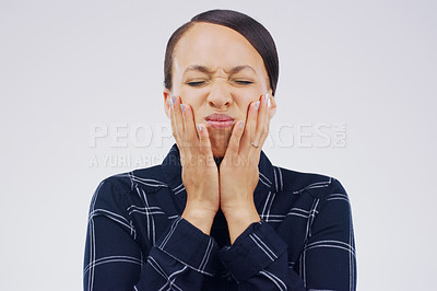 Buy stock photo Studio shot of an attractive young woman looking stressed out against a grey background