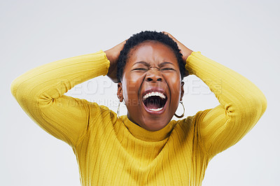 Buy stock photo Studio shot of an attractive young woman looking stressed out against a grey background