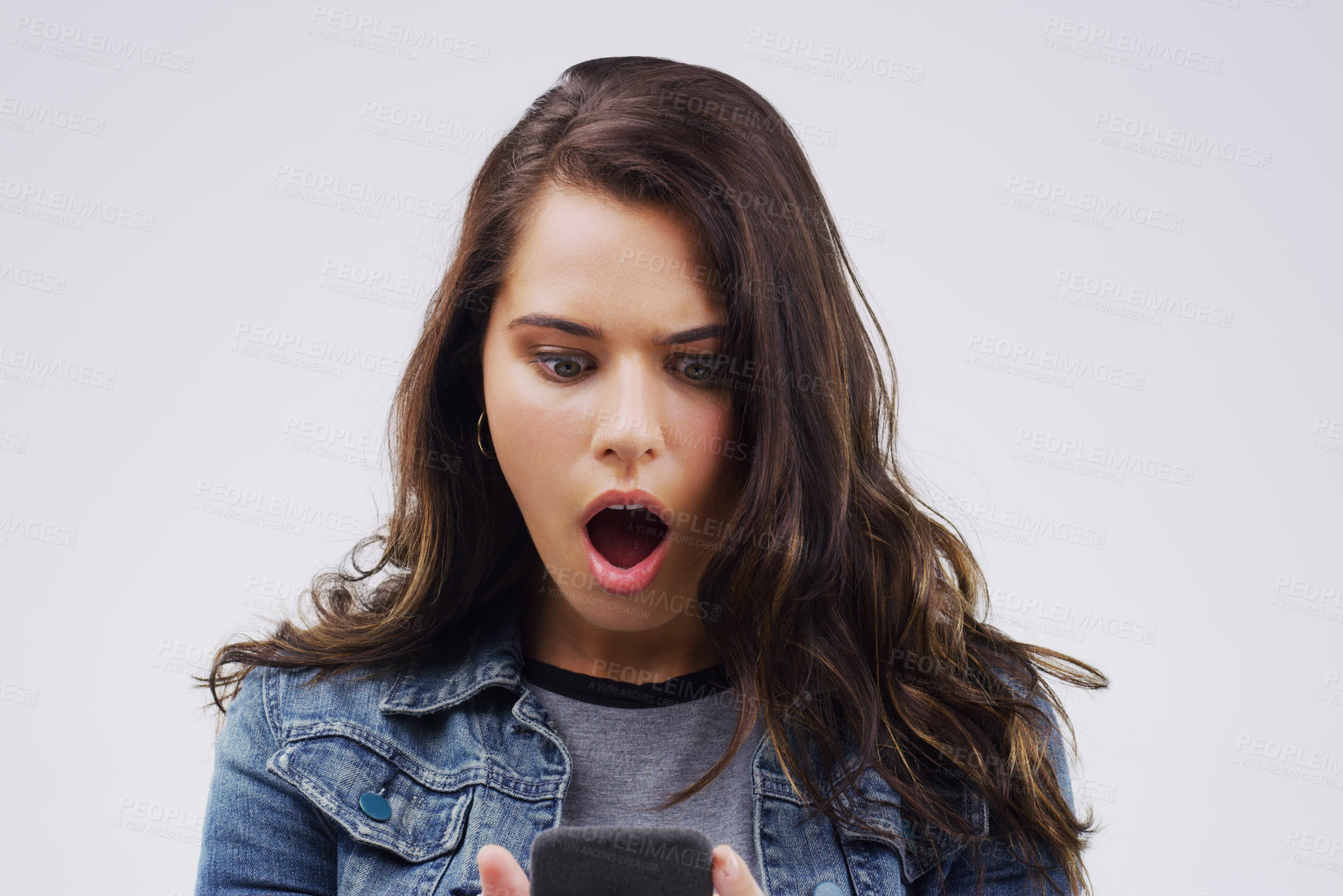 Buy stock photo Woman, wow and cellphone in studio for surprise, emoji and contact and social media for networking. Gen z, female student and influencer with shock for technology, meme and secret online by backdrop