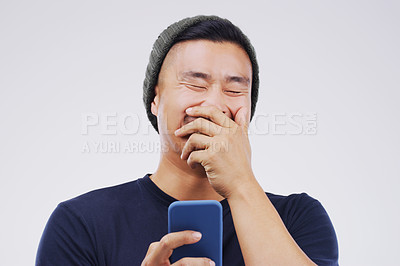 Buy stock photo Smile, funny and Asian man with a smartphone, connection or happiness against grey studio background. Male person, happy or guy with a cellphone, mobile app and meme with social media, humor or comic