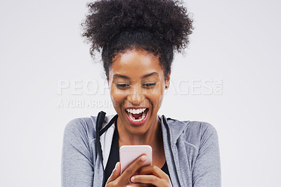 Buy stock photo Shot of a young woman reading something on her cellphone