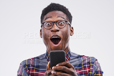 Buy stock photo Black man, surprise and phone in shock for winning, prize or good news against a white studio background. Shocked or surprised African male person with mobile smartphone, wow or lottery competition