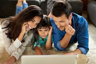 Buy stock photo Floor, mom and dad with child for laptop, streaming film and cartoon for movie night with relax. Home, mother and father with computer for watching, entertainment and boy for bonding with parents