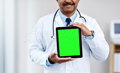 Buy stock photo Shot of an unrecognizable male doctor holding up a digital tablet in front of him  inside of a hospital during the day
