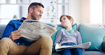 Buy stock photo Father, child and reading newspaper on sofa relaxing together in the living room at home. Happy dad and kid enjoying the news in relax on lounge couch for knowledge on weekend or holiday at the house