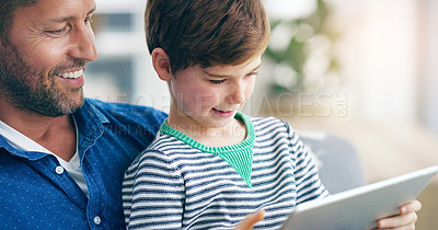 Buy stock photo Relax, dad and son with tablet on sofa in home for online game, video or streaming movie together. Smile, father and child on couch with digital app for web subscription, elearning or weekend bonding