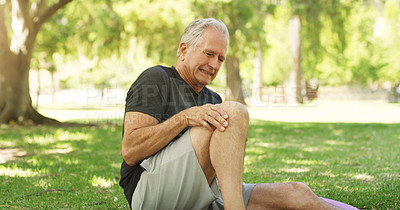 Buy stock photo Cropped shot of a senior man suffering a knee injury while out for a workout