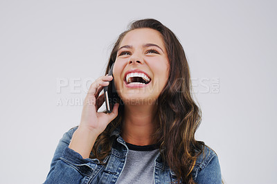 Buy stock photo Studio shot of a young woman using a mobile phone against a grey background