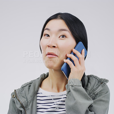 Buy stock photo Gossip, phone call and Asian woman talking in studio isolated on a white background. Listening, cellphone and female person speaking, discussion or communication for conversation, news or online chat