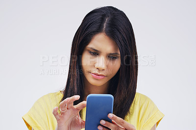 Buy stock photo Serious, phone and woman typing in studio isolated on white background for social media. Mobile, cellphone and female person texting, networking or email, web scroll or browsing online messaging app.