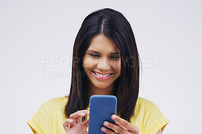 Buy stock photo Typing, smile and woman with a cellphone, connection and network against a white studio background. Female person, girl or model with a smartphone, online reading or search internet with website info